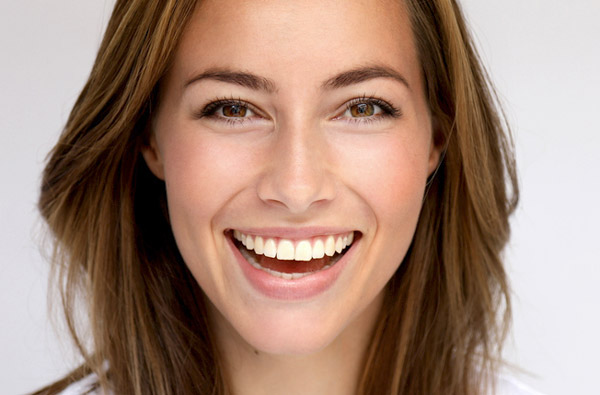 Beautiful woman smiling after cosmetic dentistry at D.A Dental in Auburn, MA Beautiful woman smiling after cosmetic dentistry at D.A Dental in Auburn, MA